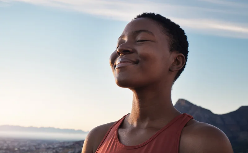 girl smiling and breathing deeply, feeling balanced