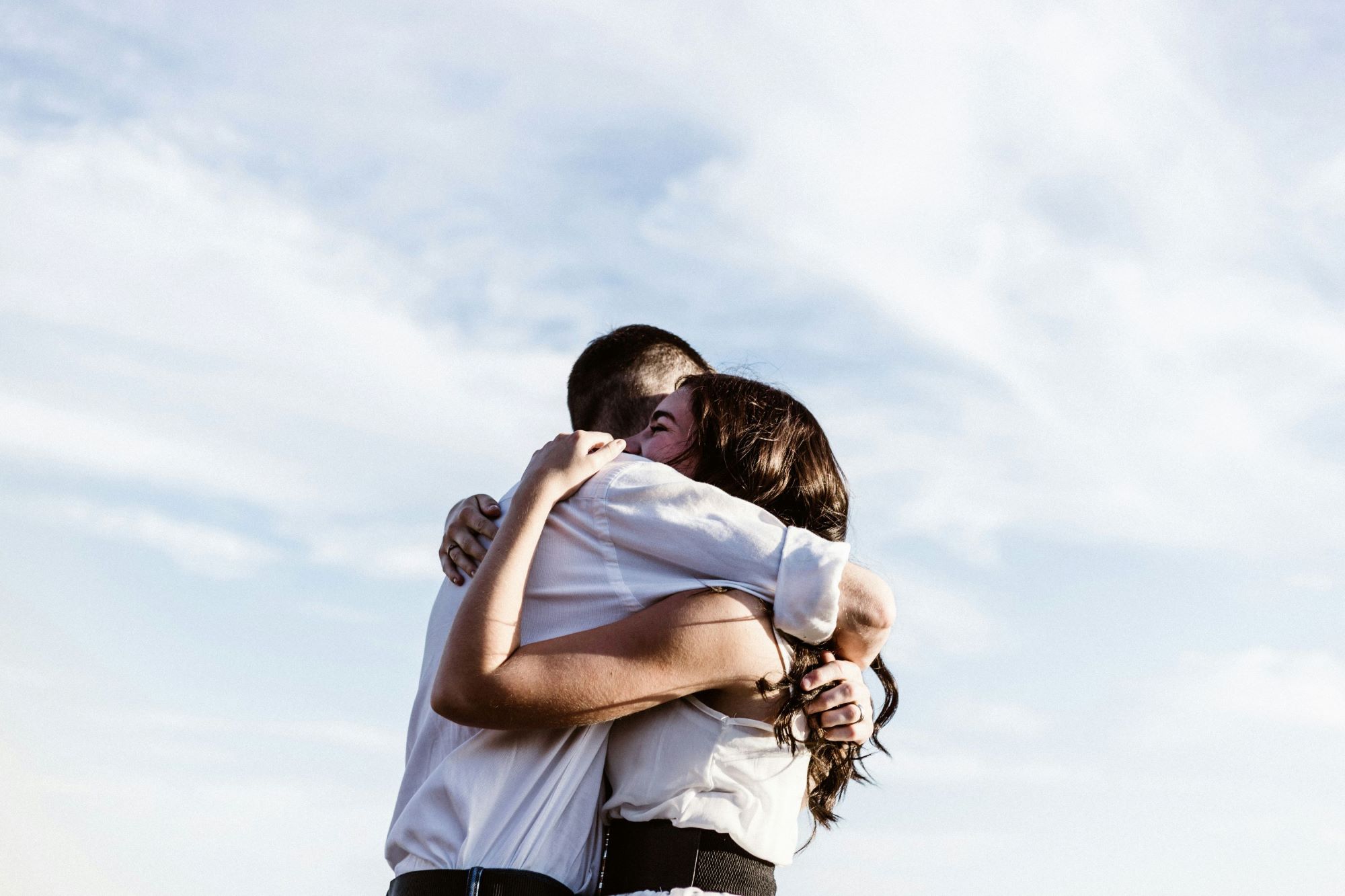 Couple hugging affectionately, representing emotional connection, intimacy, oxytocin, and relationship bonding.
